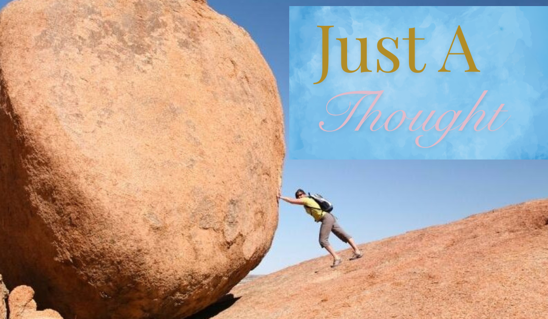 Just a thought photo of hiker pushing boulder up a hill